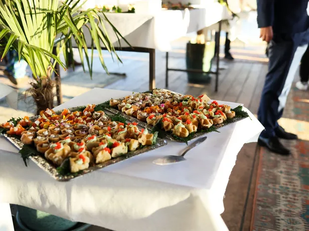 Trays of appetizer bites plated for an outdoor catered event