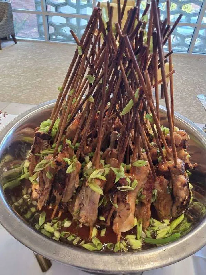 Skewered appetizers arranged in a tower on a serving platter