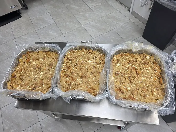 Three full pans of bread pudding prepared for a community meal