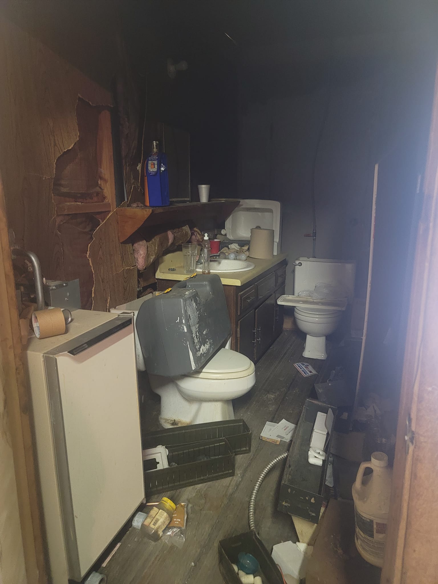 An old washroom with the wall lining opened up